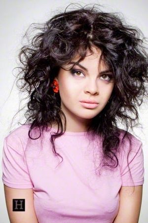 Women's Medium Length Curly Shag Hairstyle, With Warm Black Hair Pertaining To Most Popular Shaggy Hairstyles For Long Curly Hair (View 5 of 15)