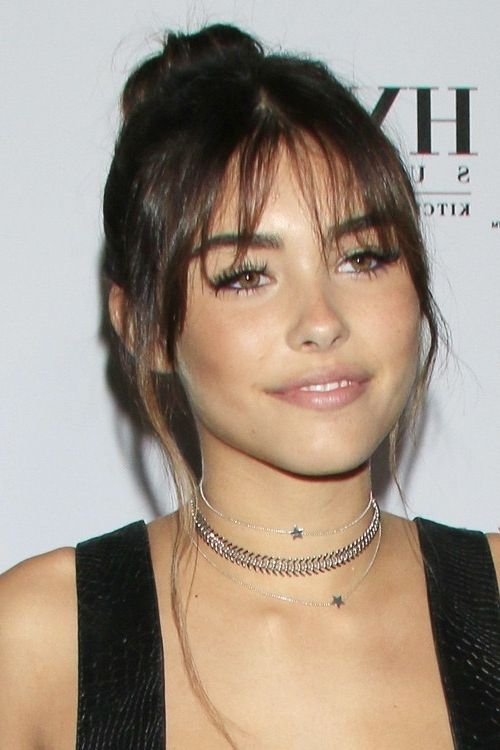 Madison Beer Straight Dark Brown Bun, Curved Bangs, Updo Hairstyle Pertaining To Minaj Pony Hairstyles With Arched Bangs (View 20 of 25)