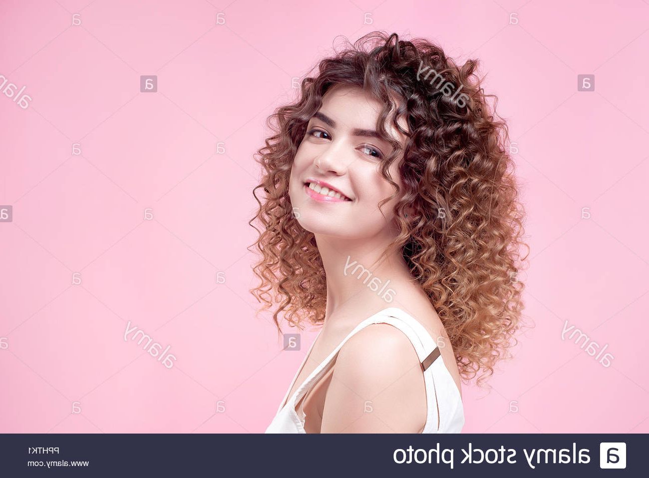 Happy Smiling Young Woman With Amazing Hairstyle Curly Shine Hair In Inside Curly Hairstyles With Shine (View 13 of 25)