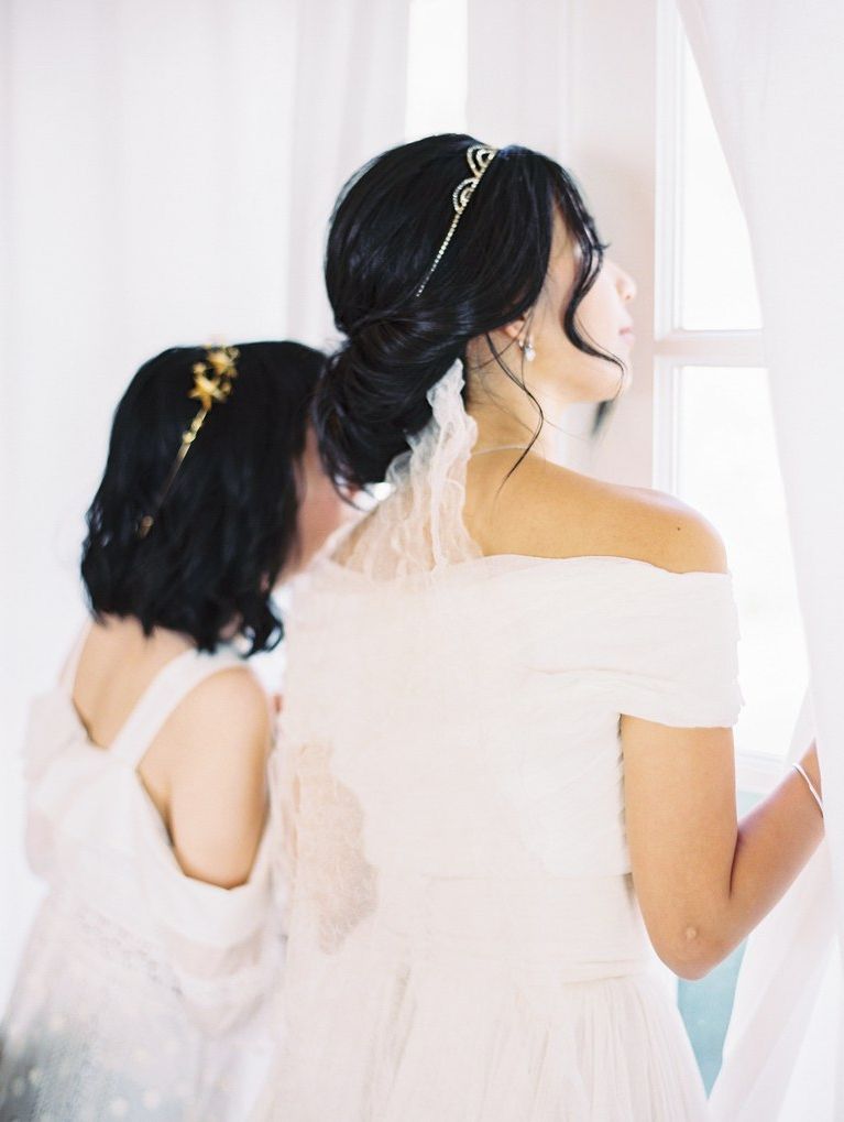 Loose Low Bun Wedding Hairstyle With Veil Tucked Underneath | Brides In Sparkly Chignon Bridal Updos (View 23 of 25)