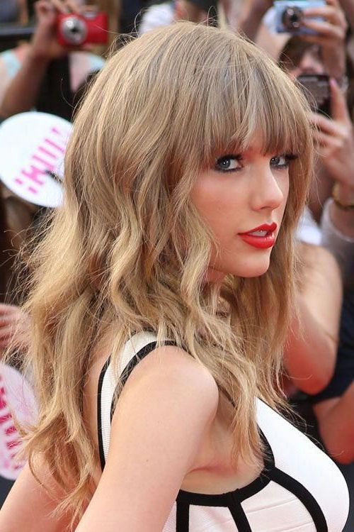 Taylor Swift Wavy Ash Blonde Choppy Layers, Straight Bangs With Curly Ash Blonde Updo Hairstyles With Bouffant And Bangs (View 6 of 25)