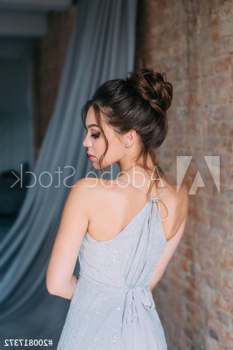 Young Girl In A Gray, Evening Dress Posing On The Camera (View 9 of 25)