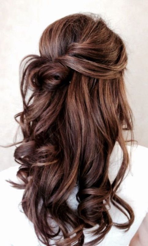 Picture Of A Twisted And Wavy Half Updo With A Bun Is A Within Simple Half Bun Hairstyles (View 17 of 25)