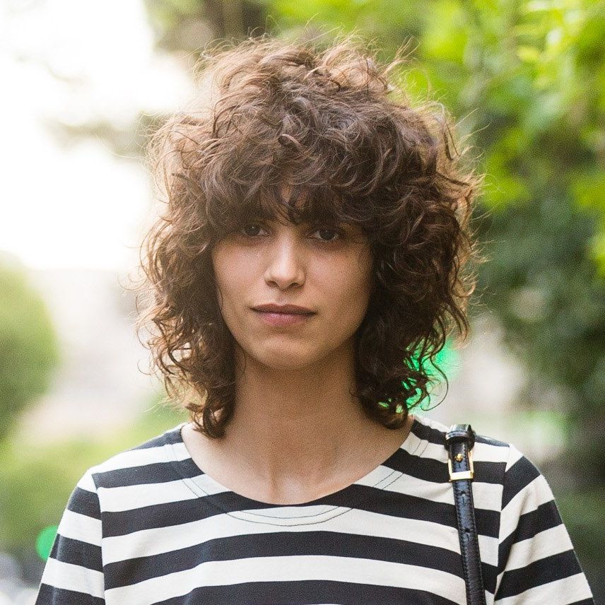 Tips For Great Bangs With Curly Hair | Allure With Regard To Soft And Casual Curls Hairstyles With Front Fringes (View 12 of 25)