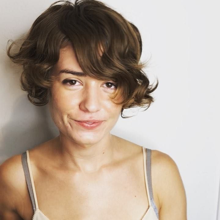 Women's Brunette Asymmetric Pixie Bob With Long Side Swept Inside Short Asymmetric Bob Hairstyles With Textured Curls (Photo 11 of 25)