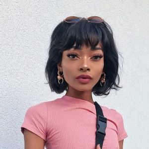 21 Flawless Black Hairstyles With Bangs (2021 Trends) Inside Wavy Textured Haircuts With Long See Through Bangs (Photo 18 of 25)