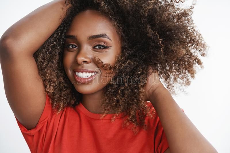 Close Up Shot Of Carefree Relaxed And Tender African American Female Model  In Red T Shirt Playing With Curly Hair Stock Photo – Image Of Lady,  Emotions: 148634532 With 2018 Carefree Curls Haircuts (View 20 of 25)