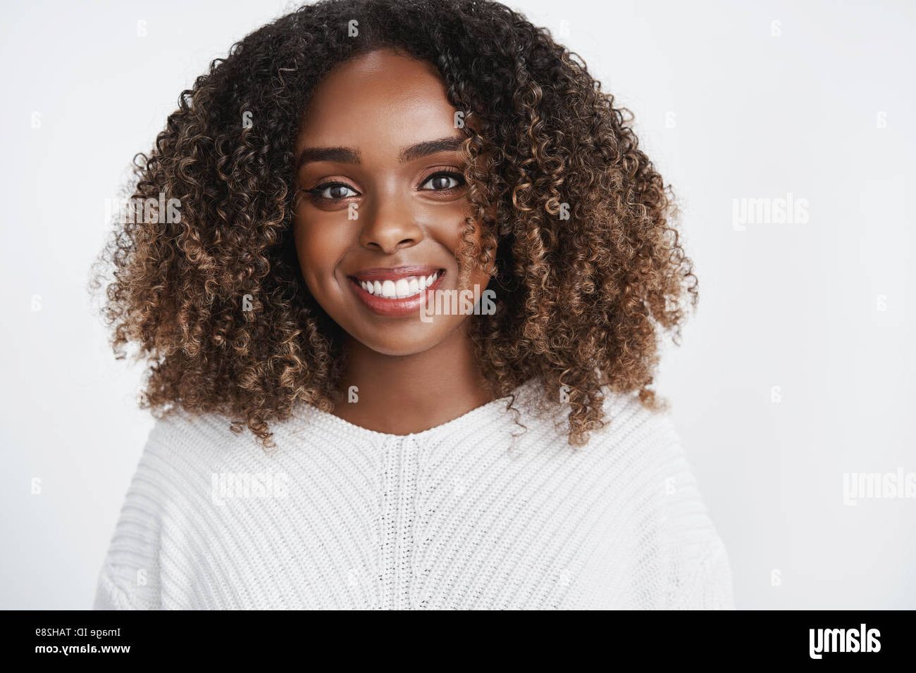 Close Up Shot Of Relaxed And Joyful African American Young Female Student  In Sweater With Curly Haircut Smiling Delighted And Carefree Being In Good  Stock Photo – Alamy Throughout Most Current Carefree Curls Haircuts (View 16 of 25)
