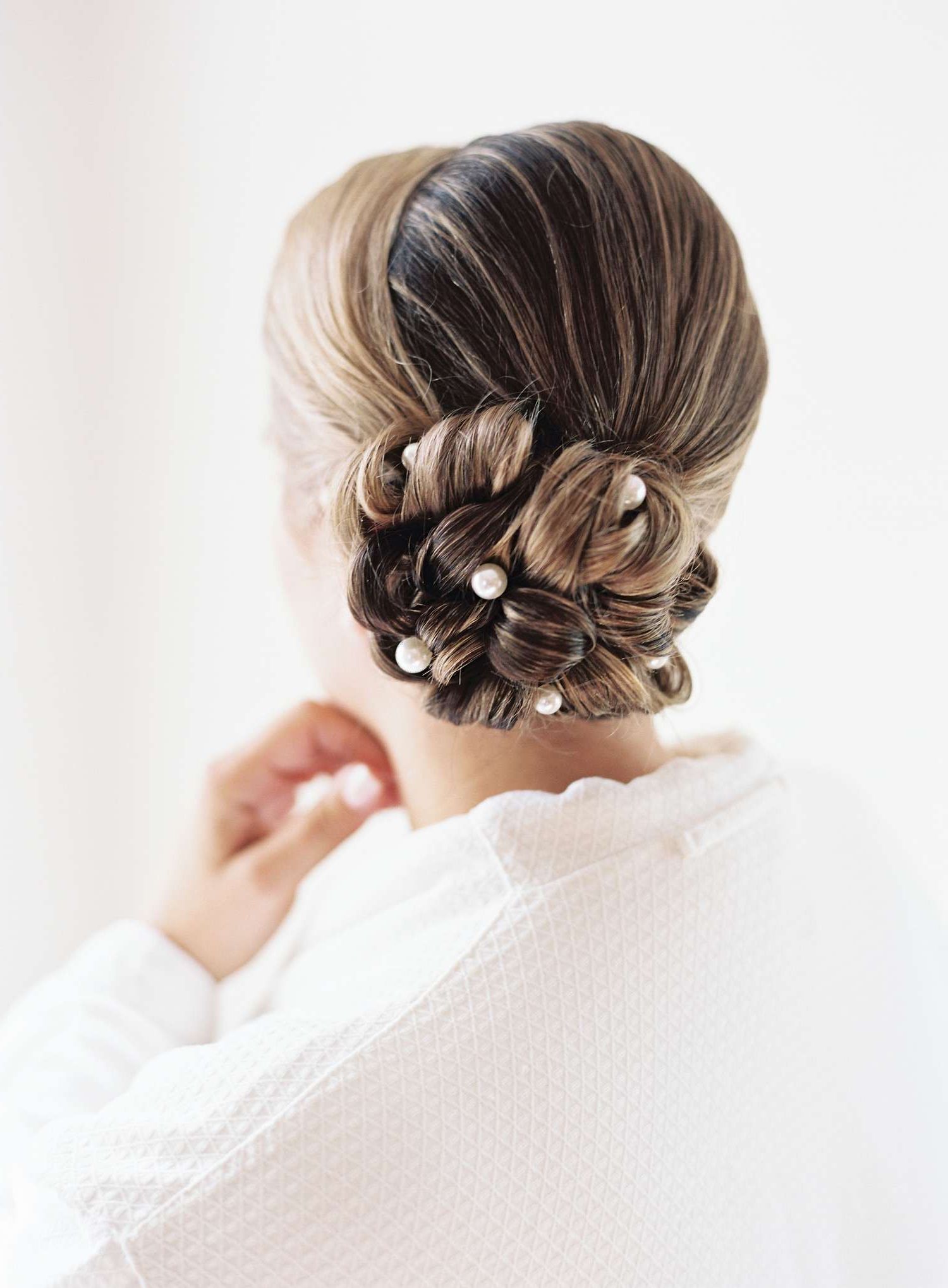 10 Low Bun Wedding Hairstyles For Every Type Of Bride Regarding Low Chignon Updo (View 10 of 28)