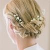 Undone Low Bun Bridal Hairstyles With Floral Headband (Photo 15 of 25)