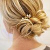 Large Curly Bun Bridal Hairstyles With Beaded Clip (Photo 6 of 25)