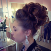 Large Curly Bun Bridal Hairstyles With Beaded Clip (Photo 13 of 25)