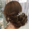 Undone Low Bun Bridal Hairstyles With Floral Headband (Photo 20 of 25)