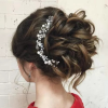 Large Curly Bun Bridal Hairstyles With Beaded Clip (Photo 1 of 25)