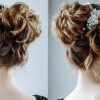 Wavy Low Bun Bridal Hairstyles With Hair Accessory (Photo 24 of 25)