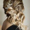 Large Curly Bun Bridal Hairstyles With Beaded Clip (Photo 2 of 25)