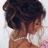 Large Curly Bun Bridal Hairstyles With Beaded Clip (Photo 8 of 25)