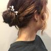 Wavy Low Bun Bridal Hairstyles With Hair Accessory (Photo 23 of 25)