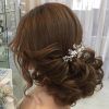 Large Curly Bun Bridal Hairstyles With Beaded Clip (Photo 23 of 25)