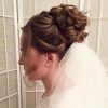 Curly Bridal Bun Hairstyles With Veil (Photo 1 of 25)
