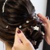 Curly Wedding Updos With Flower Barrette Ties (Photo 25 of 25)