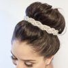 Large Curly Bun Bridal Hairstyles With Beaded Clip (Photo 4 of 25)