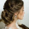 Wavy Low Bun Bridal Hairstyles With Hair Accessory (Photo 2 of 25)