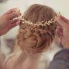 Wavy Low Bun Bridal Hairstyles With Hair Accessory (Photo 13 of 25)